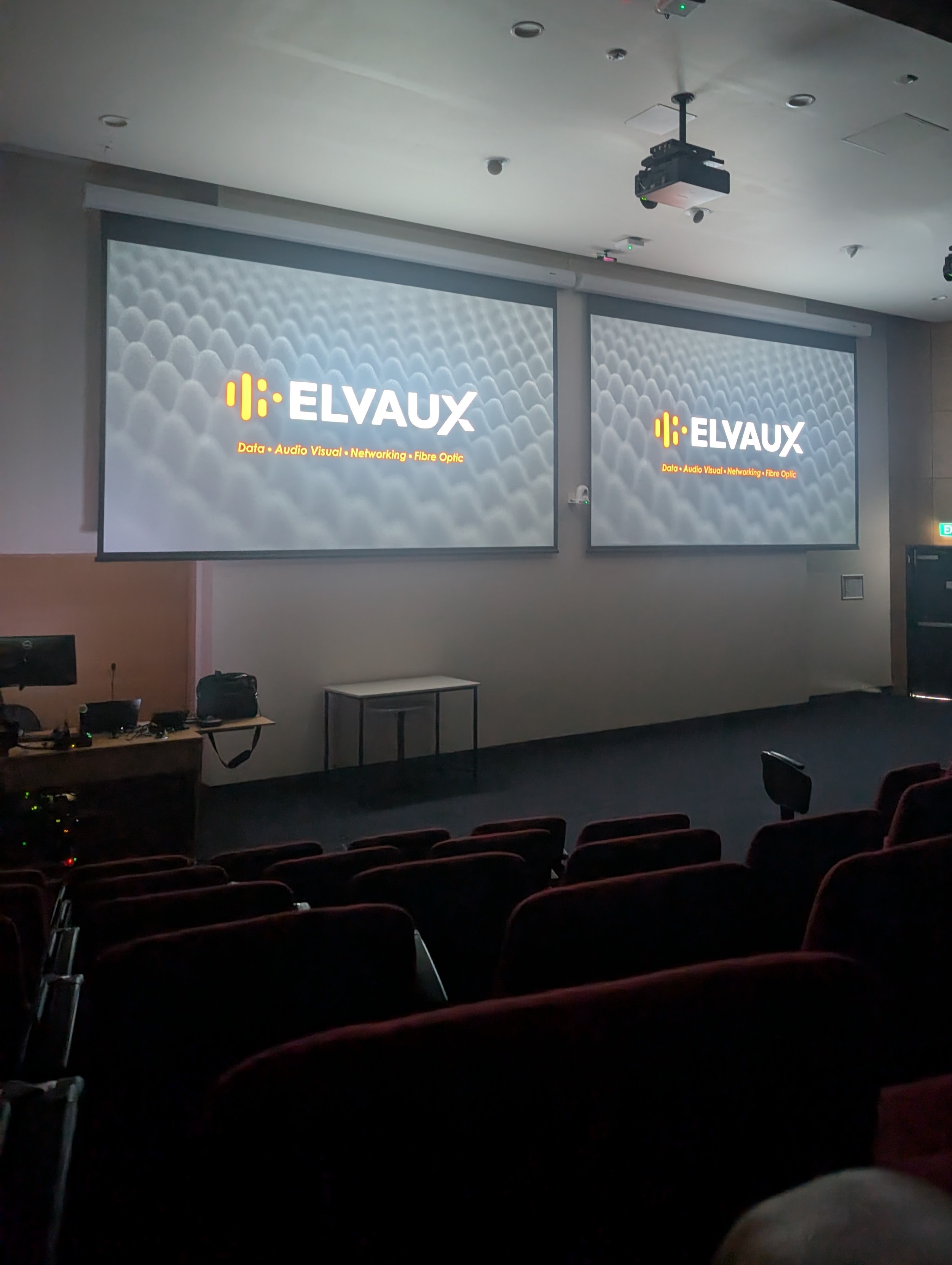University auditorium with dual projection screens and presentation systems