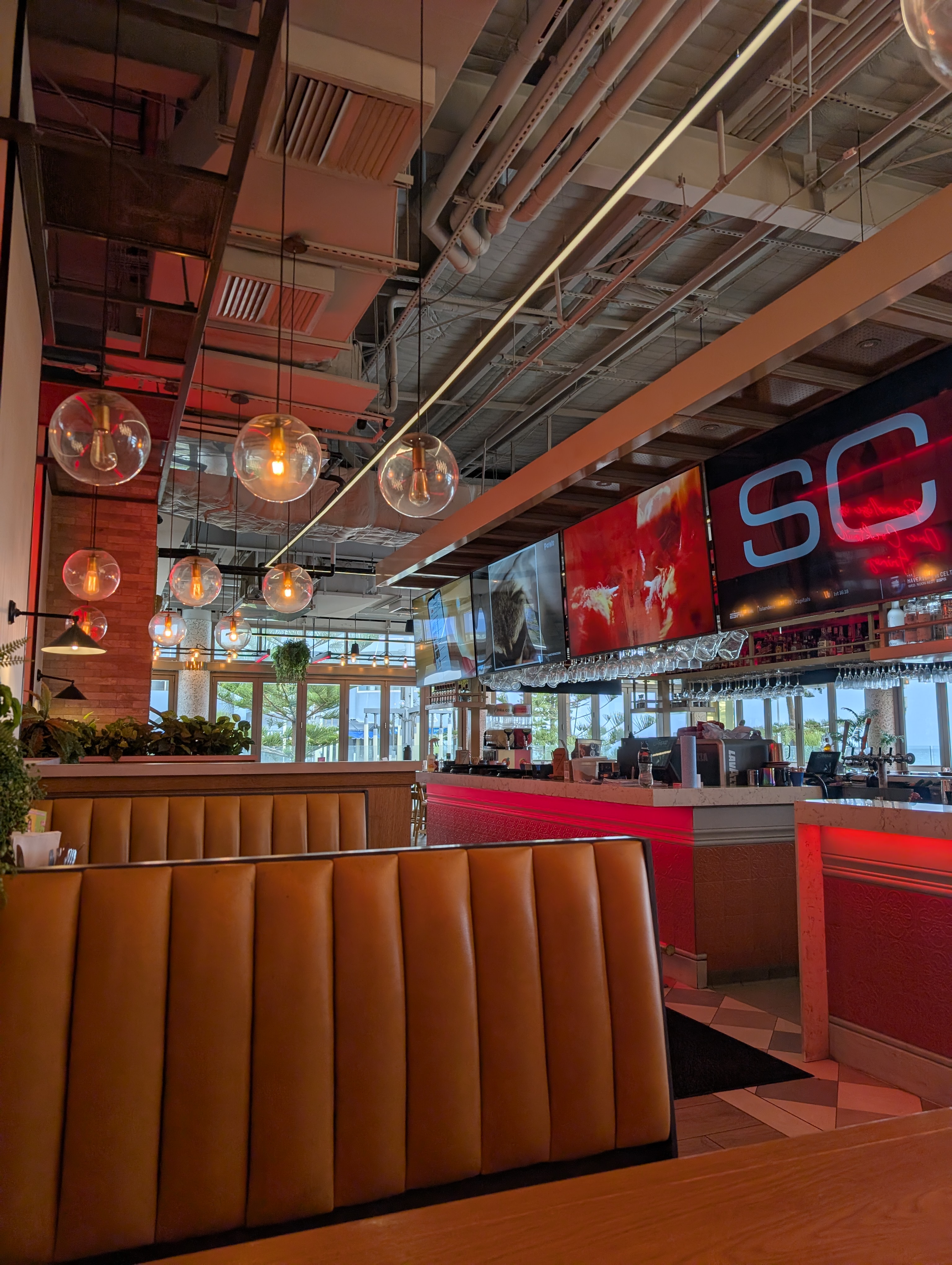 Pub interior with bar IPTV displays and architectural lighting
