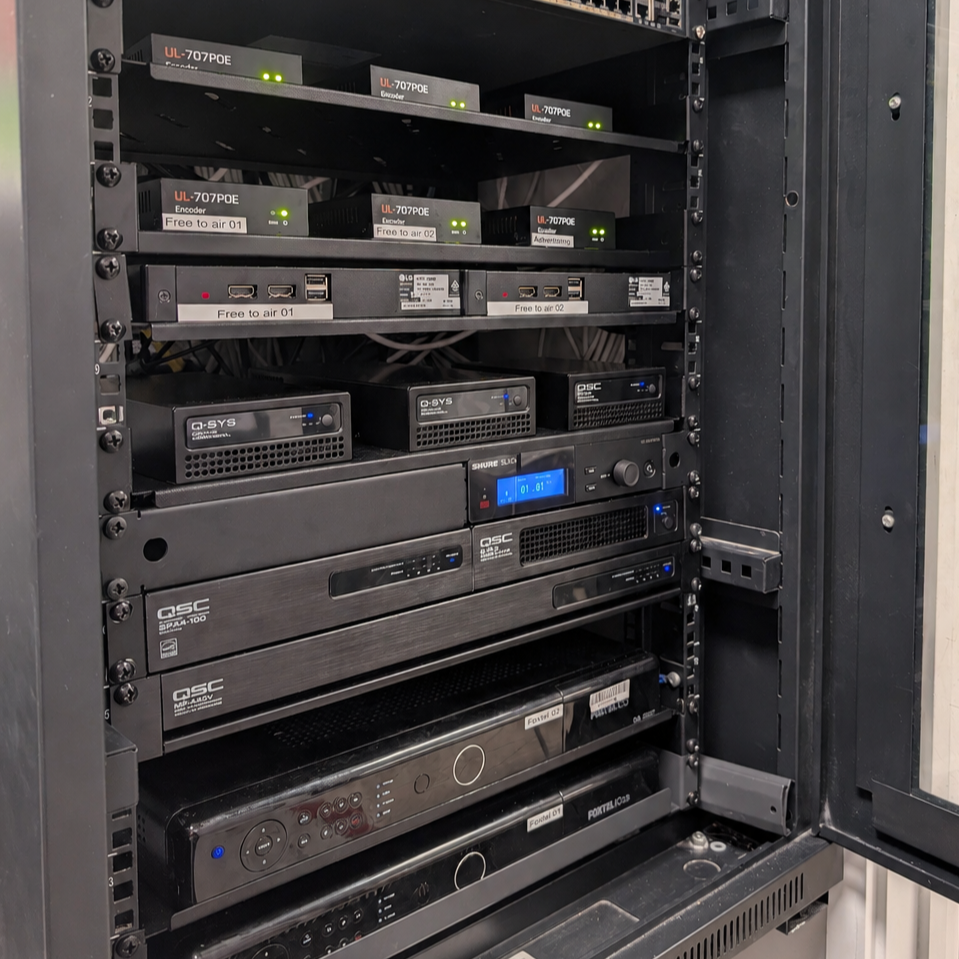 AV rack with Q-SYS core, IPTV encoders, wireless, and amplification